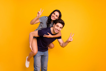 Photo of cheerful nice good charming couple of two people showing you v-sign toothily smiling while...