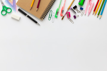Top view of school supplies on a white background