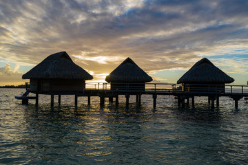 Luxury overwater villas during sunrise and Otemanu mountain at Bora Bora island, Tahiti, French...