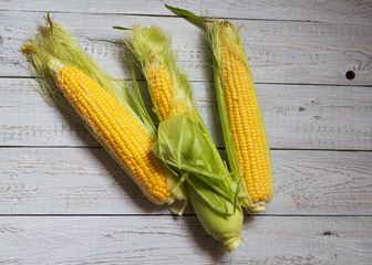 Corn natural fresh on a wooden background for cooking.