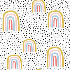 Obraz premium Childish seamless pattern with hand drawn rainbow and dots. Trendy kids vector background.