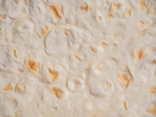 Fototapeta na wymiar thin wheat cake - pita bread. Food background, close up