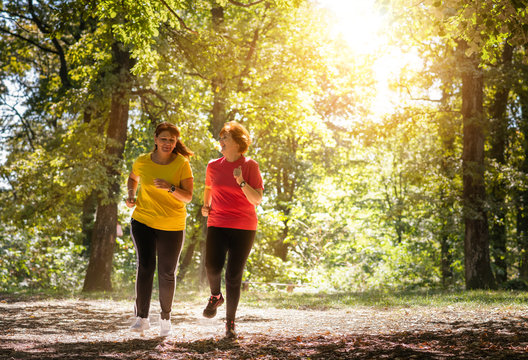 Two middle aged women running