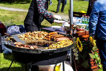 Meat and vegetables cooked on the grill. Streetfood. Hot roast chicken