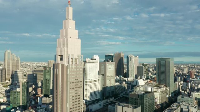 day orbiting left around top of DTT Docomo Yoyogi building in Shinjuku Tokyo