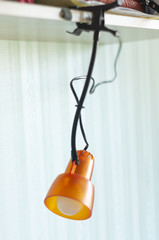orange clothespin table lamp. conveniently mounted lamp