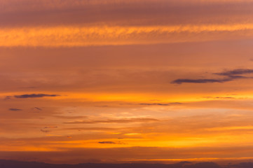 Abstract nature background. Dramatic sunset sky in the clouds saturated with bright colors of orange and yellow. Contrast Low Key