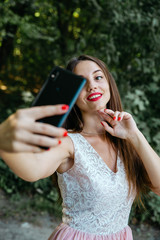 Beautiful girl doing a self-portrait on the phone