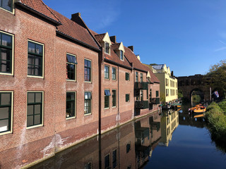 Fototapeta na wymiar Boats in a canal around the Berkelpoort in Zutphen