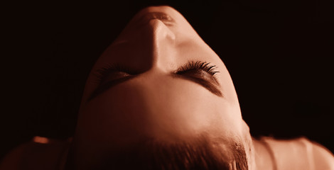 Play of light. Half of female face in light