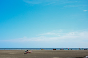 Fototapeta premium Wooden fishing boats on beach are used as a background.