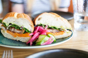 close up of mexican torta sandwich on table at restaurant