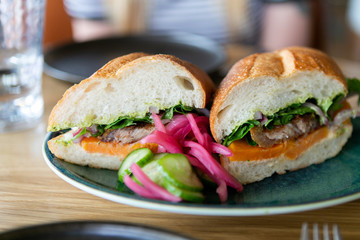 close up of mexican torta sandwich on table at restaurant