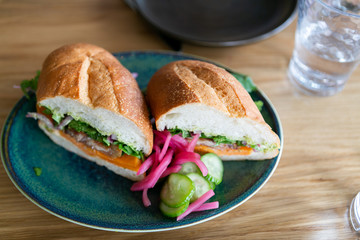 close up of mexican torta sandwich on table at restaurant
