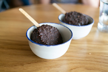 Chocolate dipped ice cream with coconut coating 