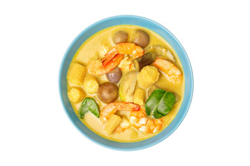 Top view plate of thailand green curry soup with coconut milk and shrimps isolated at white background.