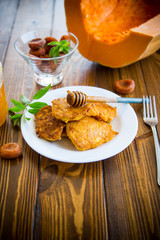 tasty fried sweet pumpkin pancakes with honey