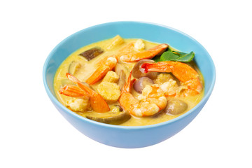 Closeup plate of thailand green curry soup with coconut milk and shrimps isolated at white background.