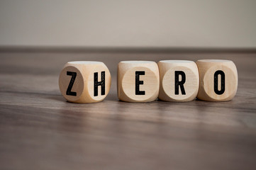 Cubes and dice with words from zero to hero on wooden background - obrazy, fototapety, plakaty