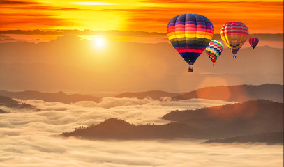 Fototapeta na wymiar Hot air balloons flying over sea of mist at sunrise in Chiang Mai, Thailand.