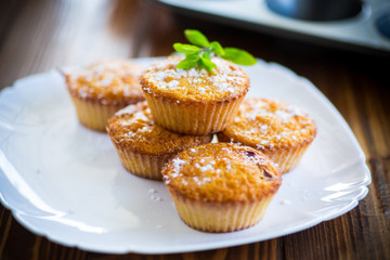 baked sweet pumpkin muffins with dried apricots inside,