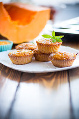baked sweet pumpkin muffins with dried apricots inside,