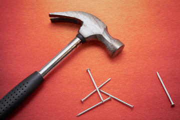 Hammer and a bunch of construction nails closeup. Repair concept.