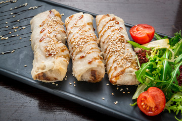 Homemade hot dog wraps in pita on black background