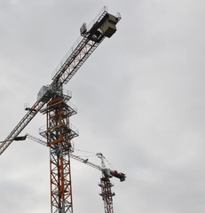 Industry. Construction. A high-altitude crane lifts building materials.