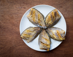 Thai food fried salid fish cut in stripes.  Trichogaster pectoralis on wooden background