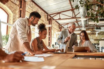 Office life. Group of business people working together and communicating in the modern office