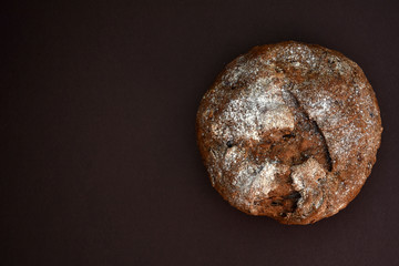 Whole grain rye bread, isolated on dark background. Closeup