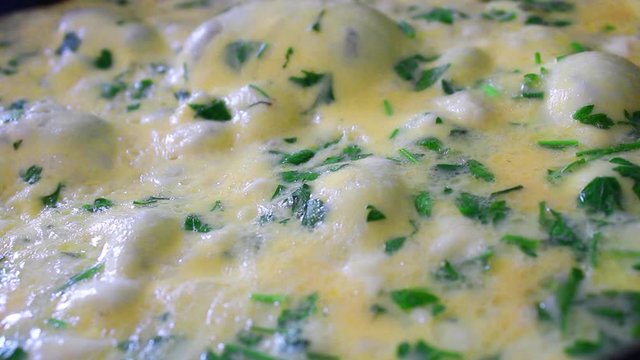 Cooking omelet with vegetables and cheese