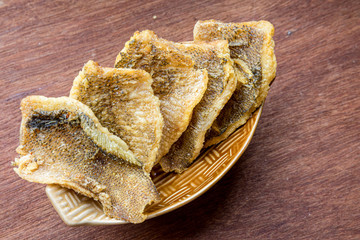 Fried Trichogaster pectoralis cut in slice fry for crispy on wooden background, Salid fish thai food