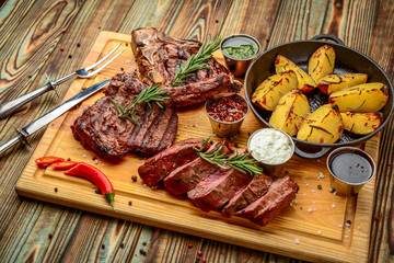 Grilled meat, porkchop with potatoes in pan