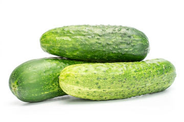 Group of three whole fresh green pickling cucumber isolated on white background