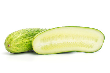 Group of one whole one half of fresh green pickling cucumber cross section isolated on white background