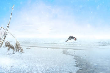 Extreme athlete swimming in winter in a frozen lake