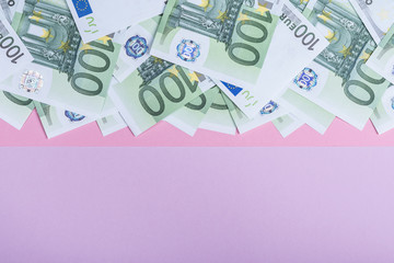 Euro cash on a lilac, purple and pink background. Euro Money Banknotes. Euro Money. Euro bill. Place for text.