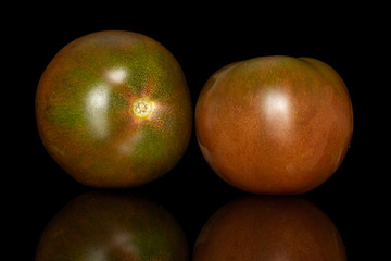 Group of two whole fresh green red tomato isolated on black glass