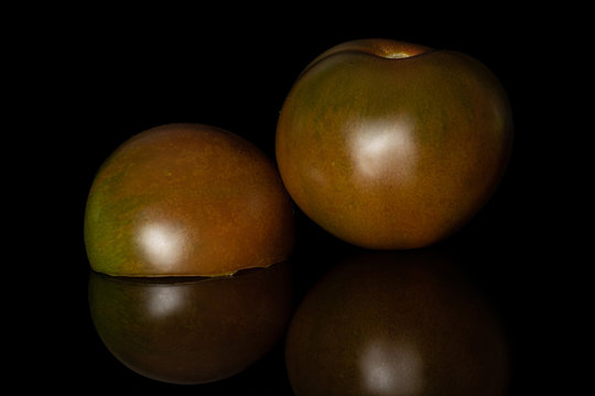 Group of one whole one half of fresh green red tomato isolated on black glass