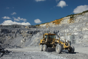 Wheel bulldozer in a quarry for the extraction of limestone close-up. Mining industry. Heavy equipment.