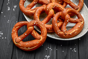 Fresh bavarian pretzels on a wooden table, pretzel with salt