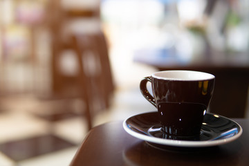 cup of coffee and beans on wooden table