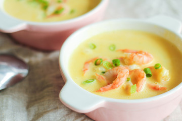 Tasty cream soup with fresh shrimps on table