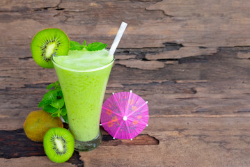 Kiwi yogurt fruit juice smoothie green colorful fruit juice milkshake blend beverage healthy high protein the taste yummy In glass,drink episode morning on wood background.