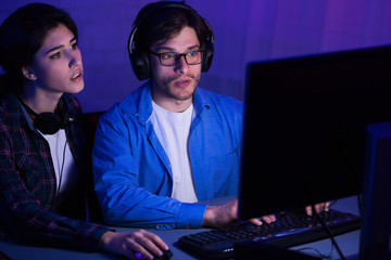 Couple of gamers playing online video game