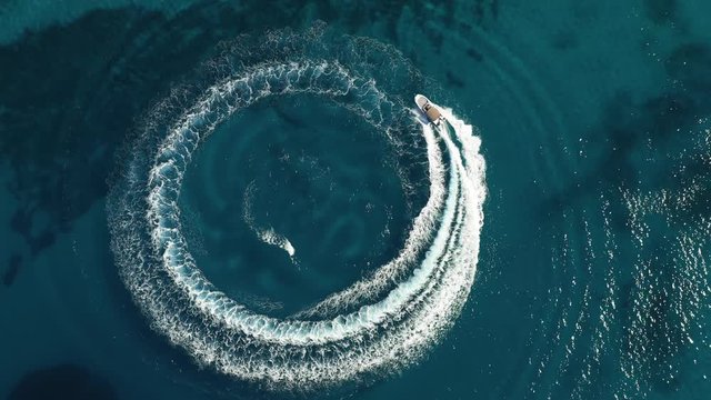 Aerial shot of speedboat riding in a circle in the sea. Top travel destination. 4K. Croatia