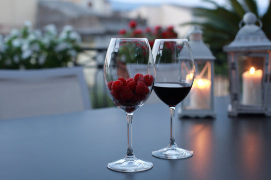 Two glasses of wine on table at the romantic sunset