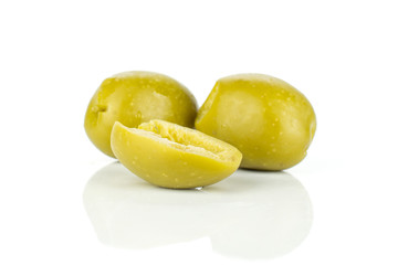 Group of two whole one half of pitted green olive isolated on white background